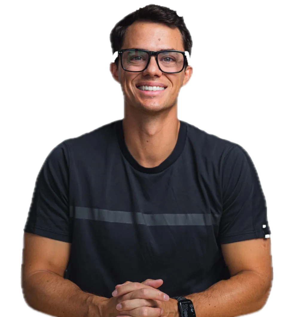 Andy Isom, smiling, at his desk