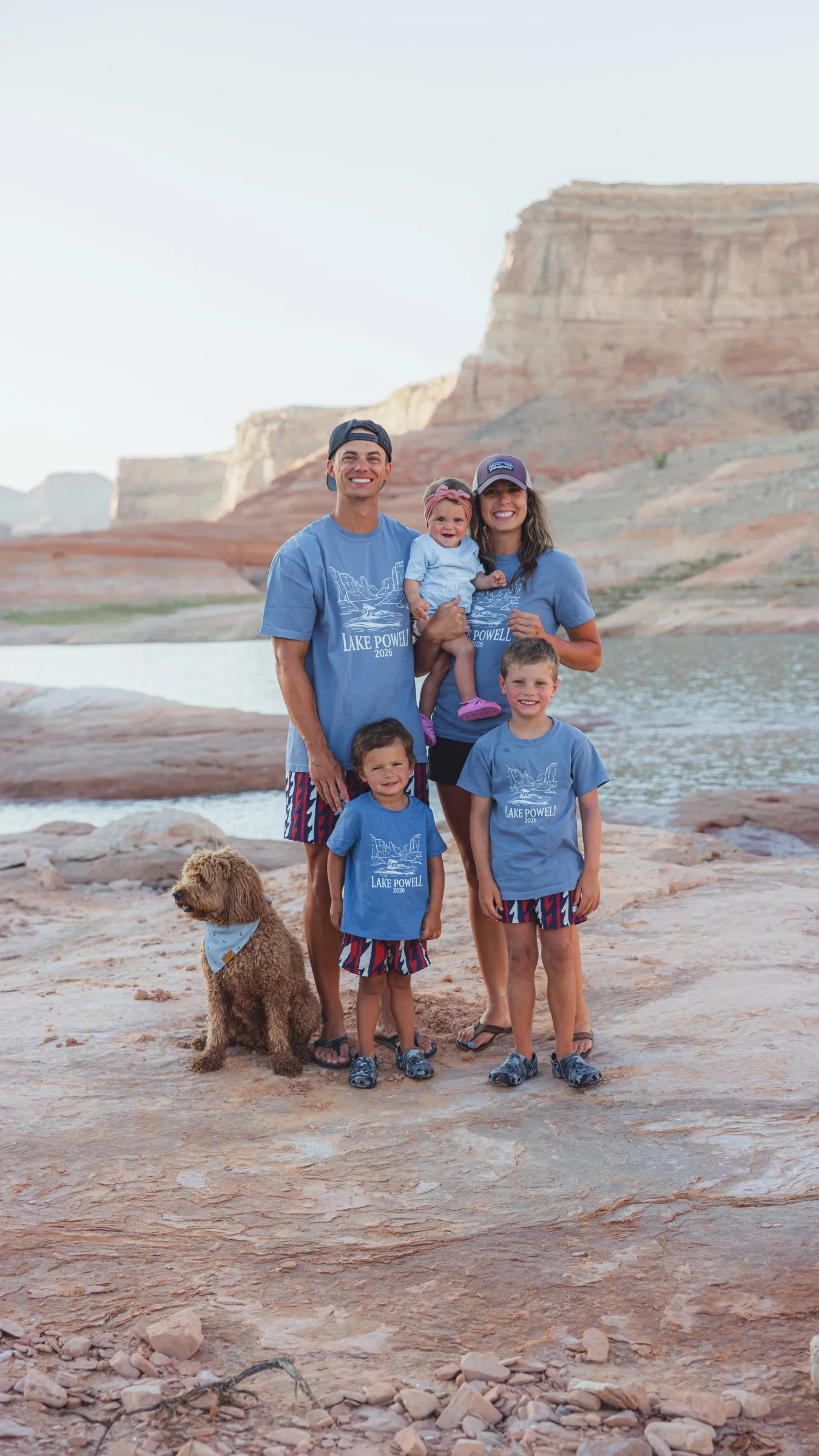 Andy, his wife and their three kids with the family dog at Lake Powell, in matching Lake Powell 2026 shirts