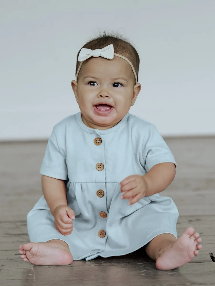 A child in the BRIN Penelope Dress, Cloud Blue, from BRIN's launch photoshoot